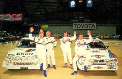 21º Toyota Olympus Rally 1986
A la derecha de la foto el 2# Lancia Delta S4 (TO 33874F) de Markku Alén - Ilkka Kivimaki, clasificado 1º.

A la izquierda el 1# Peugeot 205 Turbo 16 E2 (294 FPF 75) de Juha Kankkunen - Juha Piironen, clasificado 2º.

Esta victoria lo proclamó Campeón del Mundo a Markku Alén.

El éxito en la reclamación del Equipo Peugeot en Diciembre por la exclusión en el 28º Rally Sanremo, produjo que todos los puntos del Rally para el Campeonato se anulasen.
Eso significó que Sanremo de 1986 no pudo considerarse una prueba de WRC y por eso Markku Alén fue Campeón del Mundo durante tan solo 10 dí­as.

Última aparición Oficial de los coches Grupo B en una prueba válida para el Mundial de Rallys.

Como anécdota y prueba de como eran esos pilotos en esa época, en uno de los tramos Alén cometí­a un error garrafal al querer entrar sin darse cuenta en sentido contrario a un control horario. Kankkunen, todo un deportista y señor, (proclamado Campeón del Mundo ese año 1986 después de la reclamación de Peugeot), le avisó del error que estaba cometiendo, pudiendo Alén rectificar la trayectoria antes de que le significara una sanción.

Caballeros y amigos ante todo es lo que eran esos pilotos en esa época !!.

Y una segunda anécdota.
Este rallye pudo decidir el Campeonato de España de aquel año que ya había finalizado unas semanas antes.

En aquella época se daban puntos por participar en pruebas internacionales y Renault España barajó la posibilidad de inscribir a Sainz en el Olympus con el Tour de Corse (el Maxi correría en la misma clase que los Gr.B oficiales por lo que difícilmente puntuaría).

Ante esa amenaza, Lancia puso a disposición de Serviá un Delta para el mismo Rally... Ahí acabó la historia.

De 4 al 7 de Diciembre, Tacoma - Tumwater, Washington, Estados Unidos.
Superficie: tierra.

El Rally tenía un total de 540.65 km cronometrados divididos en 40 tramos especiales (uno de ellos fue cancelado SS6 Taylor Towne de 14.76 km).

Tomaron la salida 50 equipos, finalizaron 25.
@
Palabras clave: ;Juha_Piironen;Peugeot;Turbo;Grupo_B;Olympus;EE.UU;Markku_Alen;Lancia;Delta;parque_cerrado;1986