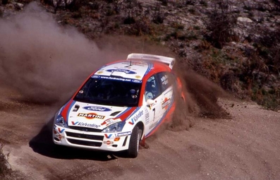Colin McRae - Nicky Grist
33º TAP Rallye de Portugal 1999. Ford Focus WRC '99 (S7 FMC). Clasificado 1º.
Ford Motor Co. Ltd.

Del 21 al 24 de Marzo, Matosinhos, Porto, Portuigal.
Superficie: tierra.

El Rally tení­a un total de 1768.61 km de los que 399.51 km divididos en 23 tramos eran especiales (dos de ellos fueron cancelados SS18 Arganil - Coja 2 de 20.96 km y SS19 Salgueiro - Gois 2 de 19.70 km).

Se inscribieron 117 equipos, tomaron la salida 117, finalizaron 56.@
Palabras clave: Ford;Focus;WRC;Portugal;1999