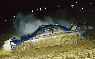 Richard Burns - Robert Reid
55º Network Q Rally de Gran Bretaña 1999. Subaru Impreza S5 WRC '99 (T 14 SRT). Clasificado 1º.

Del 21 al 23 de Noviembre, Cheltenham.
Superficie: tierra - asfalto.

El Rally tení­a un total de 1815.48 km de los que 389.39 km divididos en 22 tramos eran especiales.

Se inscribieron 186 equipos, tomaron la salida 160, finalizaron 89.

© Petr Fitz
@@
Palabras clave: Richard_Burns;Subaru;Impreza;Gran_Bretaña;WRC;1999