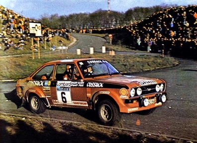 Roger Albert Clark - Stuart Pegg
25º Lombard RAC Rally 1976. Ford Escort RS 1800 MKII (POO 505R). Clasificado 1º.

Del 27 al 30 de Noviembre, Bath, Inglaterra.
Superficie: tierra.

El Rally tenia un total de 3248 km de los que 504 km divididos en 76 tramos eran especiales, (6 de ellos fueron cancelados, SS2 Speech House, km? SS34 Greystoke, km? SS37 cancelada antes del inicio, km? SS41 Egdon, km? y SS42 Anglebury, km?).

Tomaron la salida 200 equipos, finalizaron 71.@
Palabras clave: ;Stuart_Pegg;Ford;Escort;MKII;Gran_Bretaña;1976;RAC_Rally